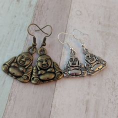 Buddha earrings, Buddha jewelry, yoga earrings, yoga jewellery, zen earrings, spiritual earrings, meditation gift, gifts for her  Materials * 15mm bronze Buddha charms * 10mm silver Buddah charms * Bronze hooks * light weight * rubber stoppers for back of earrings * earring length 2 inches Why not have a go at the LUCKY DIP https://www.etsy.com/listing/1095282417/charm-necklace-jewellery-lucky-dip-charm Add on a PERSONALISED GIFT BOX  https://www.etsy.com/listing/1170103232/add-gift-boxes-to-you Spiritual Bronze Earrings Gift, Bronze Spiritual Earrings As Gift, Nickel Free Bronze Spiritual Earrings, Spiritual Bronze Nickel-free Earrings, Spiritual Earrings, Buddha Earrings, Yoga Earrings, Buddha Jewelry, Fruit Jewelry