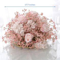 a vase filled with pink flowers on top of a table