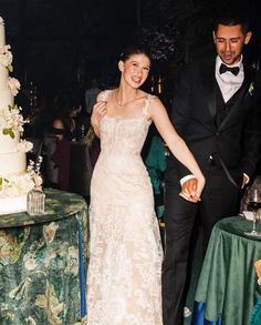 a bride and groom are cutting their wedding cake