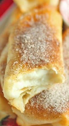 several pastries on a plate with powdered sugar sprinkled on top,