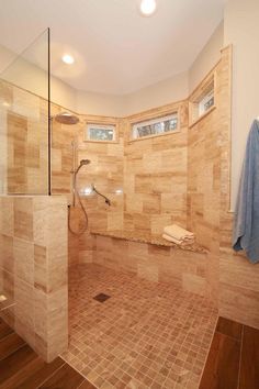 a walk in shower sitting inside of a bathroom