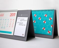 two desk calendars sitting on top of each other