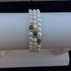 Cultured Freshwater Pearls, Green Aventurine, And Goldtone Beads Memory Wire Bracelets. Since Pearls And Gemstones Are Natural Materials, There Are Natural Differences In Each. Approx. 55mm In Diameter. Approx. 4-5mm Pearls, 2mm Goldtone Beads, And 4mm Gemstones. White Pearl Bracelets With Gemstones, White Pearl Gemstone Bracelets, White Pearl Bracelet With Round Gemstone Beads, White Pearl Bracelet With Gemstone, White Gemstone Pearl Bracelet, White Single Strand Jade Jewelry, White Gemstone Beads Rondelle Bracelet, White Rondelle Gemstone Beads Bracelet, White Pearl Beaded Bracelets With Natural Stones