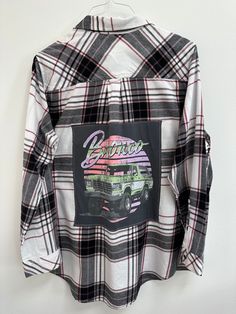 "Show off some Bronco Love in this one-of-a-kind flannel! Women's XL Sonoma upcycled flannel. Grey old school Ford Bronco tee sewn on back. Size: Women's XL Brand: Sonoma Chest: 24\" armpit to armpit Arm Length: 24\" shoulder to hem Back Length: 32\" top of collar to hem Color: Cream and black plaid with burgundy  Material: cotton All clothing is pre-washed & comes from a smoke-free home. Wash gentle cycle, cold water  Tumble dry low Don't iron over graphic tee Please check measurements, sizing Casual Flannel Shirt With Graphic Print, Long Sleeve Flannel Top With Graphic Print, Plaid Graphic Print Long Sleeve Shirt, Fall Flannel Shirt With Graphic Print, Plaid Flannel Tops With Graphic Print, Fall Long Sleeve Flannel Shirt With Graphic Print, Fall Graphic Print Flannel Shirt, Fall Graphic Print Long Sleeve Flannel Shirt, Fall Flannel Top With Graphic Print