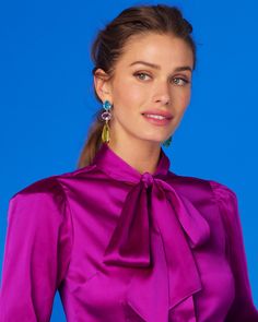 Bold and glamorous, our Ravenna Statement Earrings add colorful drama to any outfit. • Post fastening for pierced ears • Gold plated • Faceted multi-colored peridot, topaz and amethyst colored glass• Statement size • Width: 0.75"; length: 3" • 0.4 oz • Zinc free • Includes a NicoBlu gift bag (prints and colors vary) • Made in India Elegant Multicolor Earrings For Formal Occasions, Elegant Multicolor Earrings For Evening, Elegant Multicolor Earrings, Glamorous Purple Drop Earrings, Elegant Purple Clip-on Earrings, Elegant Party Earrings With Gemstone Accents, Purple Clip-on Earrings For Party, Formal Purple Earrings, Pussybow Blouse