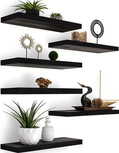 three floating shelves with plants and vases on them