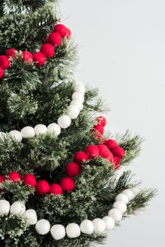 a christmas tree decorated with red and white balls