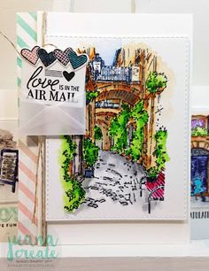 a handmade card with watercolors and ink on it that says love in the air mat