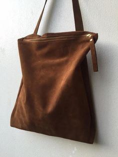 "ON SALE Brown suede bag - zipper suede tote for women. Large brown zipper suede tote bag is a women tote bag for an every day use, this brown leather bag is Made of soft brown suede leather. Soft and comfortable. This bag is one of a kind. Inside leather pocket Leather Handle zipper closure Unlined Very comfortable for carrying personal things, A4 files, i-pad , cosmetic bag and more. Available in blue/brown/black/Gray Dimentions: Height: 42 cm/ 16.53\" Width: 35 cm/ 13.77\" Handle : 71 cm / 27 Brown Bag With Suede Lining, Everyday Suede Shoulder Bag With Zipper Closure, Suede Bags With Zipper Closure For Daily Use, Suede Shoulder Bag With Zipper For Daily Use, Brown Suede Shoulder Bag With Large Capacity, Large Capacity Brown Suede Bag, Daily Use Suede Shoulder Bag With Zipper Closure, Daily Use Suede Shoulder Bag With Zipper, Daily Use Suede Bag With Zipper Closure