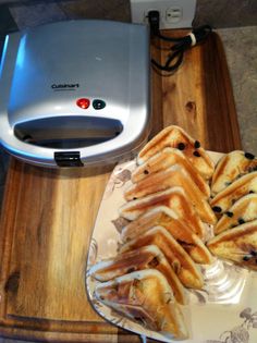 some food is laying out on a tray next to an electric toaster and paper towel