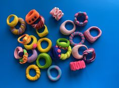 several different types of rings and bracelets on a blue background with the word love spelled in large letters