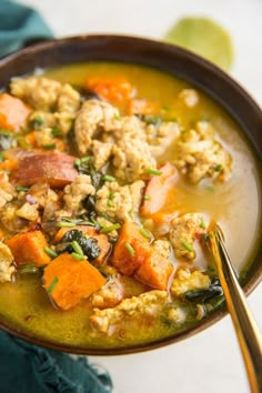 a close up of a bowl of soup with meat and veggies in it