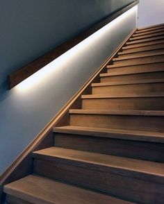 a wooden staircase with lights on the side