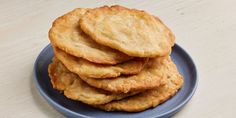 a blue plate topped with cookies on top of a wooden table