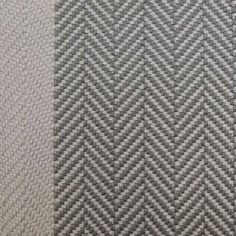 an upholstered carpet with grey and white herringbones on the bottom side