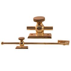 two brass plated handles with knobs on each side and one has a round handle