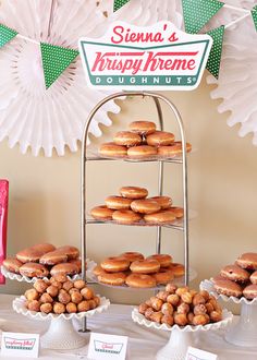 doughnuts and pastries are on display in front of a krispy kreme sign