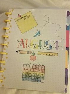 a notebook with the word august written on it