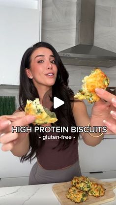 a woman is holding up some food in her hands with the caption high protein biscuits gluten - free