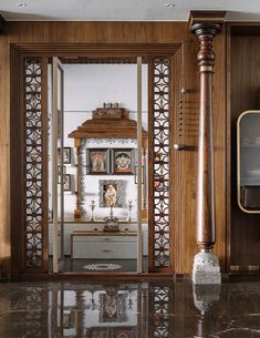 an ornate wooden room divider in front of a mirror