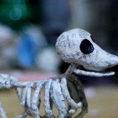 a skeleton dog figurine sitting on top of a table