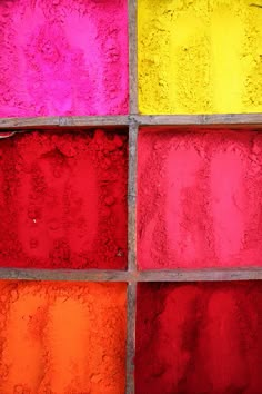 an image of colorful glass blocks in the process of being colored with colors that are red, yellow, pink, and orange