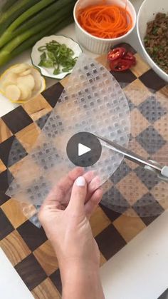 a person cutting up some food on top of a table