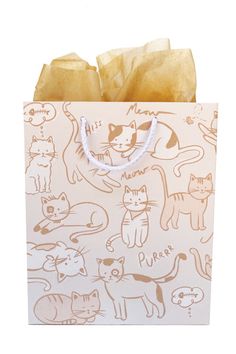 a paper bag with cats on it sitting on a white counter top next to a wall