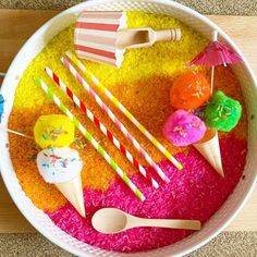 a bowl filled with lots of different types of candies and ice creams on top of rice