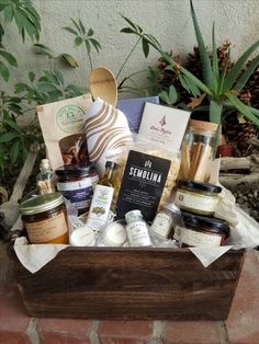 a wooden box filled with lots of food and condiments on top of a brick floor