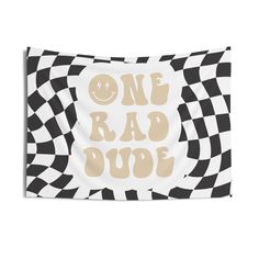 a black and white checkered wall hanging with the words one bad dude on it