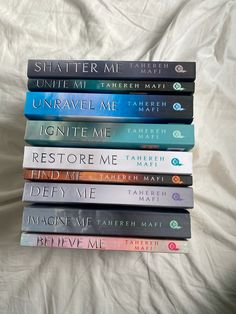 a stack of books sitting on top of a bed