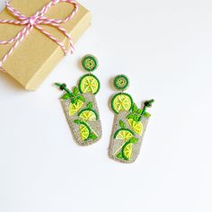 Brighten up your look with these Lime Green Drink Earrings - perfect for summer fun and pool parties! Crafted with hand-beaded detail and zesty colors, they are sure to make a splash! Summer vacation has never been tastier! 🍹💚 Great gift idea for friends, family & coworkers💕 ~ See all photos for length ~ Post back ~ Price is for 1 pair ~ Soft felt backing 📌Most Items are handmade so no two pieces are exact. Colors may vary and there can be imperfections. This is normal. Not for children. Adu Lime Mojito, Lime Drinks, Lime Margarita, Custom Gift Cards, Cocktail Earrings, Earrings Beach, Green Drinks, Beach Earrings, Fruit Earrings