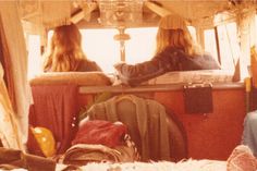 two women sitting in the back of a bus