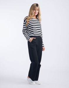 DESCRIPTION Discover the Timeless Straight Leg Ponti Pant, a wardrobe essential from White & Co. that promises comfort and style for any setting. Crafted in classic black, these pants offer a flattering, relaxed fit and showcase a subtle yet chic black tape down the sides. The perfect versatile work-to-weekend piece, they pair beautifully with a crisp white tee and classic blazer for a monochromatic look, or add a pop of colour with a patterned blouse for an effortless transition from day to nig Patterned Blouse, Black Tape, Classic Blazer, Black On Black, White Tee, Black Trim, Knit Jumper, Wardrobe Essentials, Effortless Style