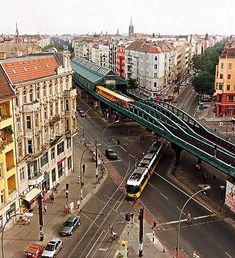 an overhead view of a city street with cars and buses driving on the road below