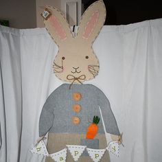 a bunny made out of fabric with carrots and bunnies on it's chest