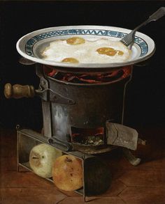 an old fashioned frying pan with fried eggs in it