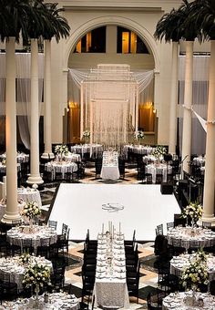 an indoor venue with tables and chairs set up for a formal function in the center