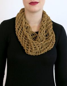 a woman wearing a brown crochet scarf