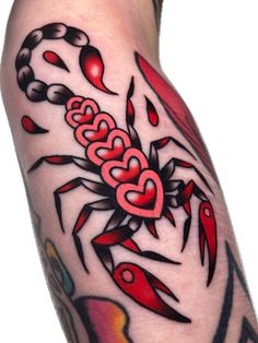 a man's arm with a crab tattoo on it and the word love written in red