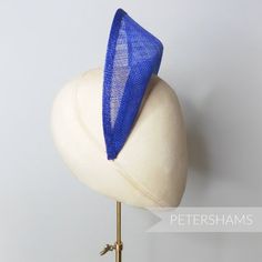 The shape of this season (and next's) has arrived! Halo crowns have stormed the millinery world and are the perfect step up from a chunky headband for a special occasion. Made from a double layer of high-quality stiffened deep royal blue sinamay, this shape has a domed front with a hollow underside, sinamay bias finished edges and tapered ends that sit nicely at the side of the head. You will need to fit a headband to this shape to make it functional, and our 5mm satin covered headbands do the j Adjustable Blue Headband For Kentucky Derby, Adjustable Blue Headband Fascinator, Blue Adjustable Headband Fascinator, Handmade Fitted Fascinator With Structured Crown, Handmade Fascinator With Structured Crown, Blue Fitted Headband For Kentucky Derby, Adjustable Blue Headband Costume Hat, Adjustable Blue Costume Headband, Blue Adjustable Headband Costume Hat