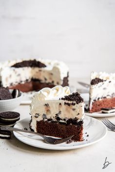 a piece of cake on a plate with a fork and oreo cookies in the background