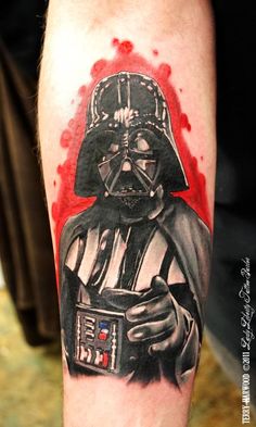 a star wars tattoo with darth vader holding a camera