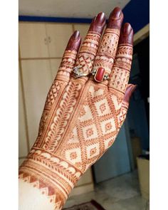 a woman's hand with henna on it