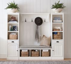 a white bench with baskets and hats on it