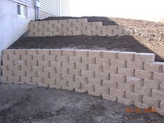 a pile of bricks sitting next to a building