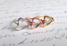 Shop: www.deannewatsonjewelry.etsy.com This sweet heart ring makes a lovely gift for a girlfriend, bridesmaids or someone special in your life.  I free formed the heart and lightly hammered the band for added strength and wrapped the heart securely in place. Super comfy and lightweight. Great for any occasion or season.  Available in sizes 3 - 12 and your choice of copper, sterling filled silver, rose filled gold or 14 gold filled  You can view my other wire wrapped rings here: http://www.etsy.c Heart Ring Gold, Girlfriend Ring, Best Friend Rings, Girlfriend Jewelry, Wire Heart, Friend Rings, Girls Personalized Gifts, Gold Heart Ring, Birthday Gifts For Teens