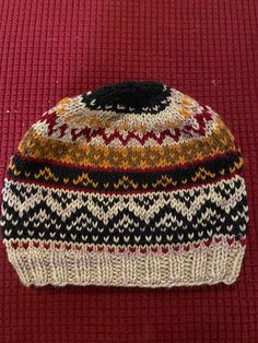 🧶 Stay Cozy with a Touch of Tradition! 🧶 Embrace the chill with our hand-knit stranded knit hat, inspired by the rich history of Fair Isle knitting from the Shetland Islands of Scotland. Each hat is meticulously crafted to offer warmth, style, and a unique flair, making it a perfect accessory for winter.  Beautiful, colorful, classy hand-knit, warm, wool winter hat. Fits adults. A picture of the inside of the hat also included. ✨ Features:     100% Hand-Knit: Every hat is lovingly created by h Nordic Warm Hats For Cold Weather, Warm Nordic Hats For Cold Weather, Nordic Style Warm Hats For Cold Weather, Multicolor Fair Isle Pattern For Winter, Winter Beanie Patterns, One Size Fits Most, One Size Fits Most Winter Beanie Pattern, Nordic Winter Multicolor Patterns, Nordic Multicolor Winter Patterns, Multicolor Nordic Winter Patterns