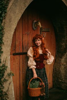 a woman with red hair is holding a basket